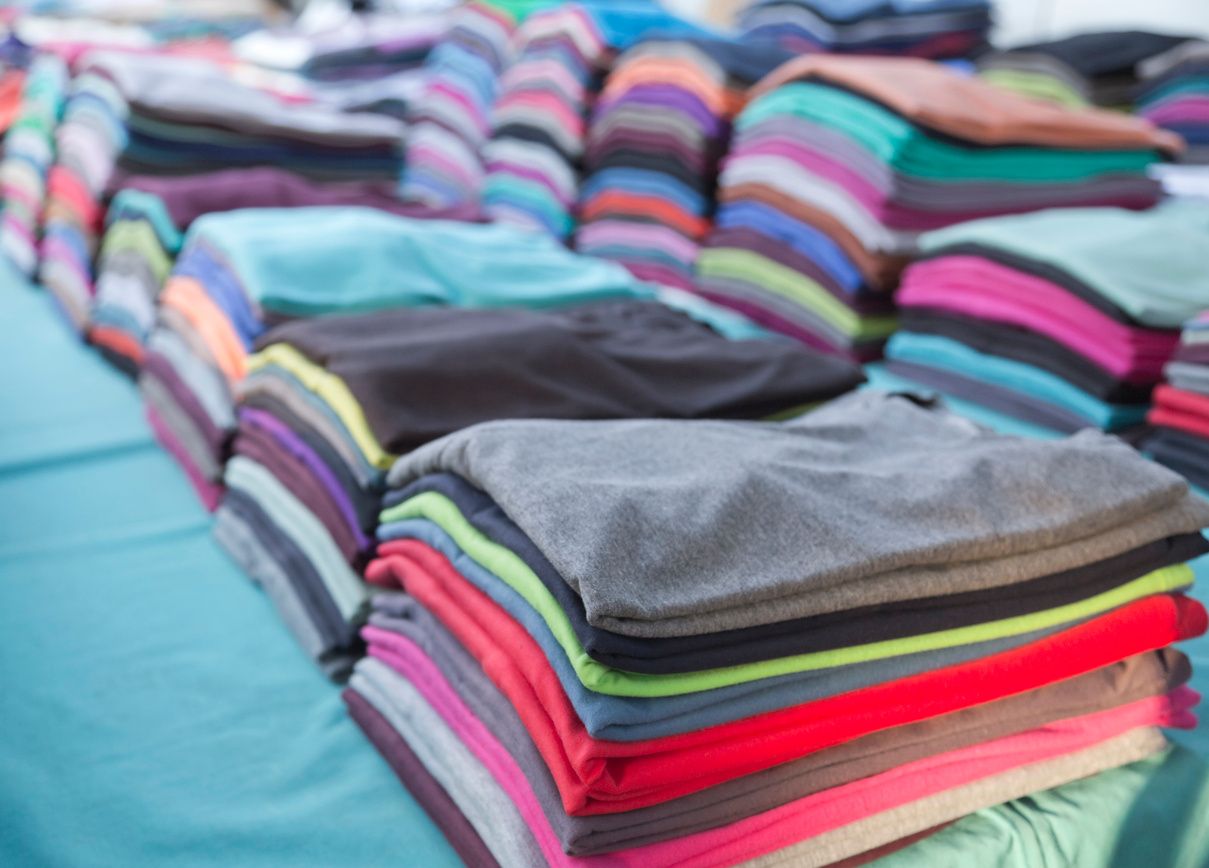 a pile of folded t-shirts